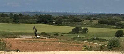 Ayoluengo Oilfeild, northern Spain, now shut in. Spain imports 99.6% of its oil needs. Wind farm in the background